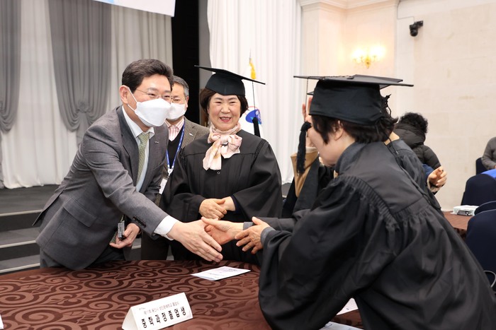 이상일 용인특례시장이 성인문해학교 졸업생들과 악수를 하고 있다.
